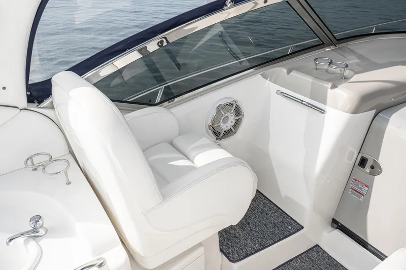 Slide: The Image of 2007 Sea Ray 340 Sundancer cockpit with white seating and cup holders. - 24
