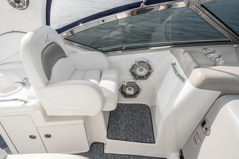 Slide: The Image of 2007 Sea Ray 340 Sundancer cockpit with white seating and marine speakers. - 25