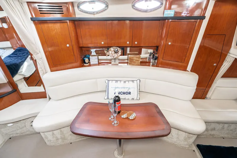 Slide: The Image of Luxurious interior of 2007 Sea Ray 340 Sundancer yacht with elegant seating and wooden cabinetry. - 38