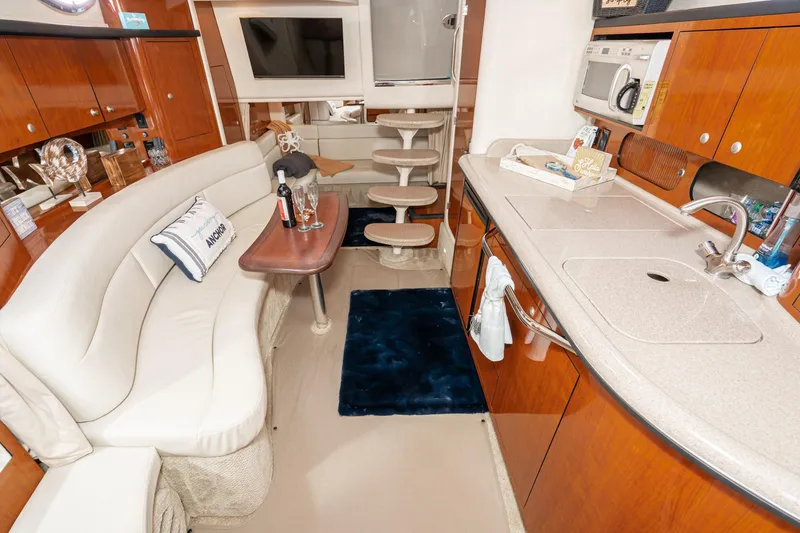 Slide: The Image of Luxurious interior of 2007 Sea Ray 340 Sundancer yacht with kitchen and seating area. - 39