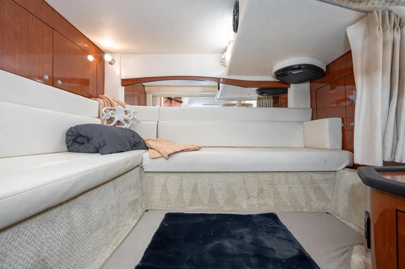 Slide: The Image of Interior of 2007 Sea Ray 340 Sundancer yacht with white seating and wood accents. - 48