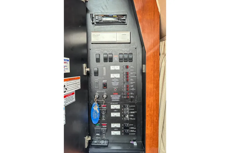 Slide: The Image of Electrical control panel of 2007 Sea Ray 340 Sundancer boat with switches and labels. - 52