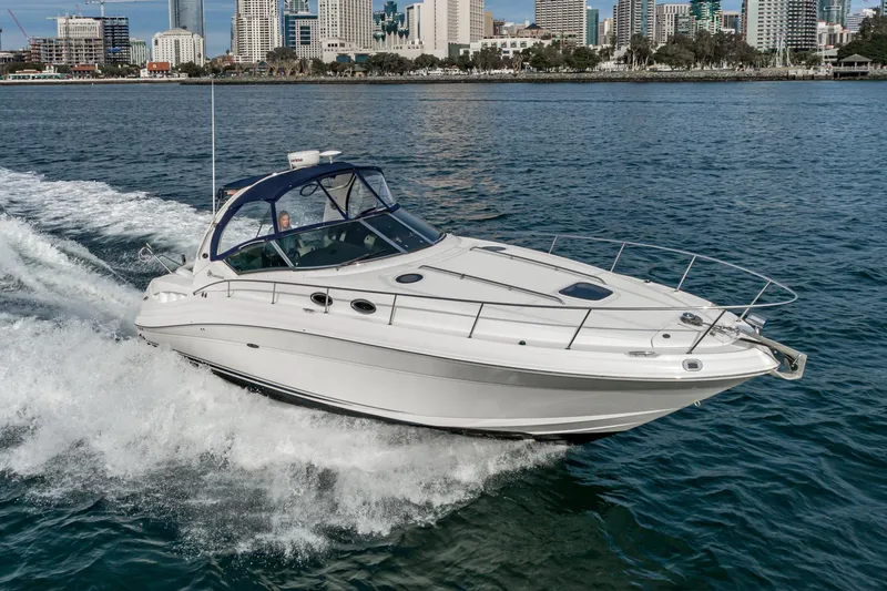 Slide: The Image of 2007 Sea Ray 340 Sundancer cruising on water near city skyline. - 6