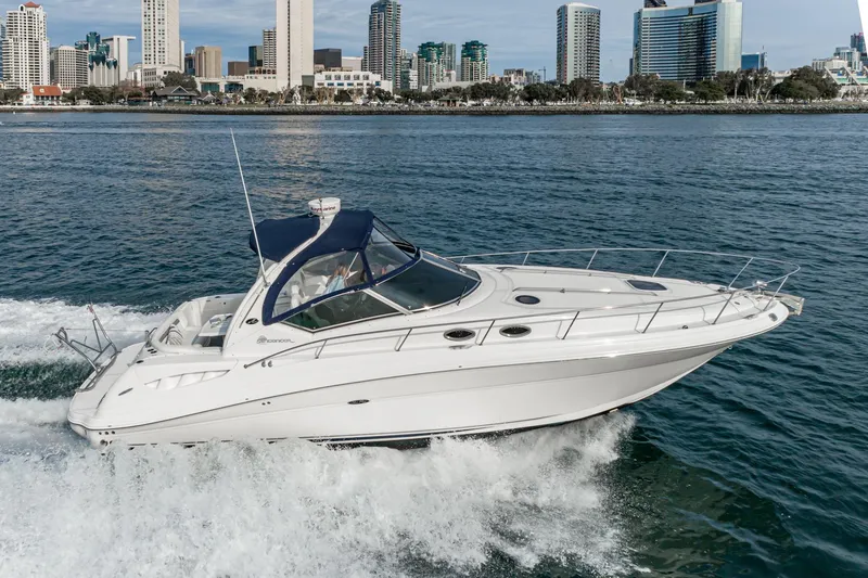 Slide: The Image of 2007 Sea Ray 340 Sundancer cruising on water with city skyline in background. - 8