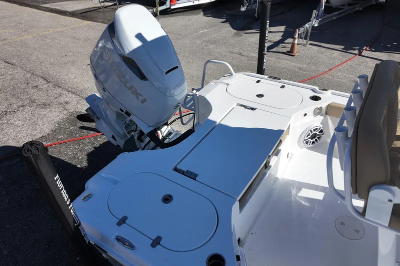 Slide: The Image of 2026 Blazer Bay 2440 boat with Suzuki outboard motor, featuring spacious deck and seating. - 10