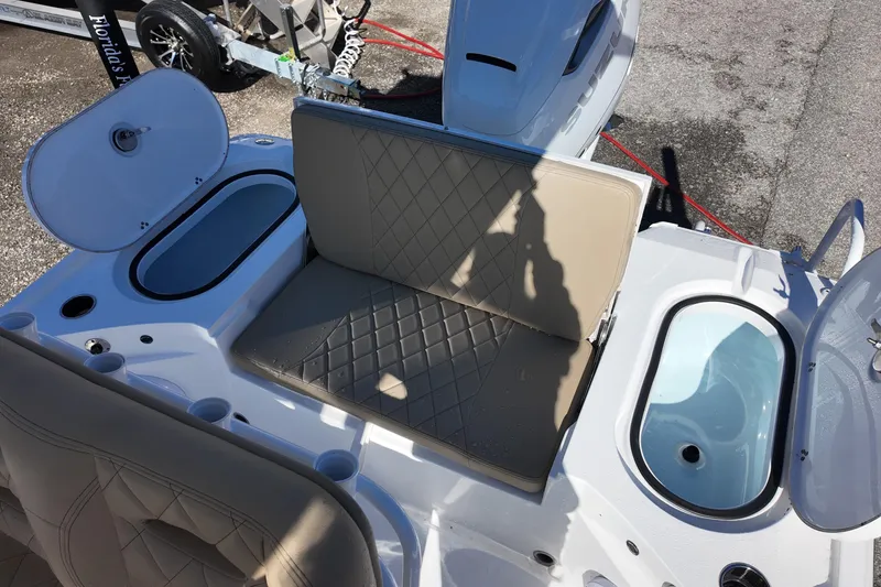 Slide: The Image of 2026 Blazer Bay 2440 boat interior with cushioned seating and storage compartments. - 11
