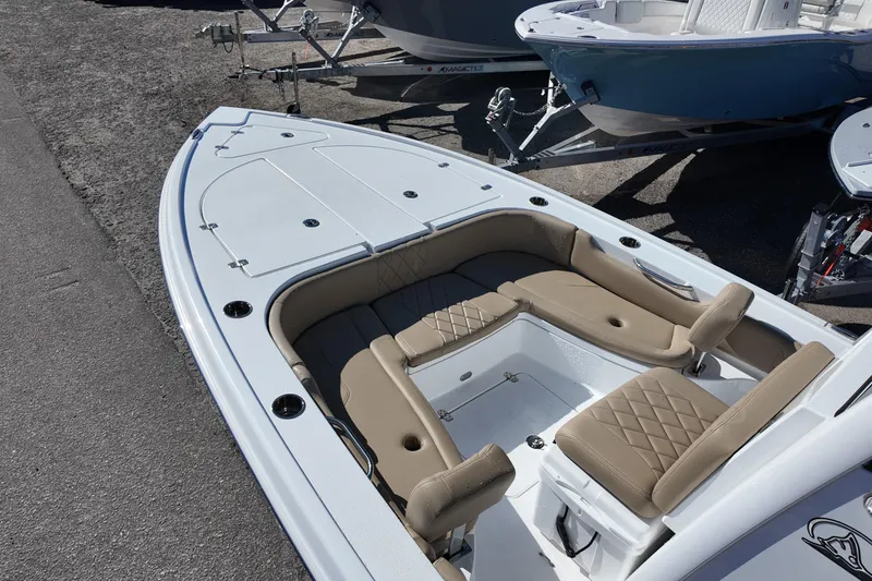 Slide: The Image of 2026 Blazer Bay 2440 boat with beige seating and spacious deck layout. - 6