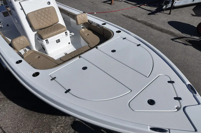 Slide: The Image of 2026 Blazer Bay 2440 boat with tan seating and spacious deck. - 7