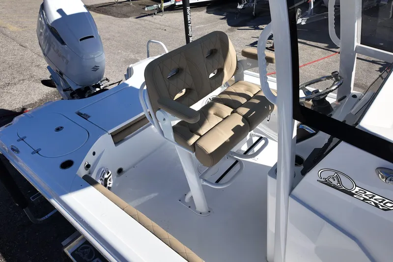 Slide: The Image of 2026 Blazer Bay 2440 boat interior with beige seating and steering console. - 9