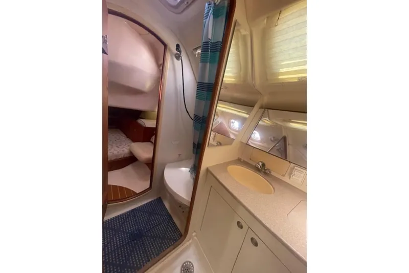 Slide: The Image of Interior of 2001 Hunter 380 yacht featuring bathroom and cabin area. - 13