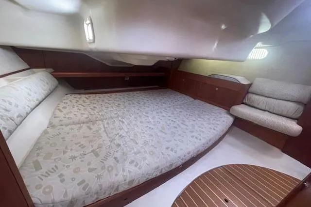 Slide: The Image of Cozy cabin interior of a 2001 Hunter 380 sailboat with a spacious bed and seating area. - 15