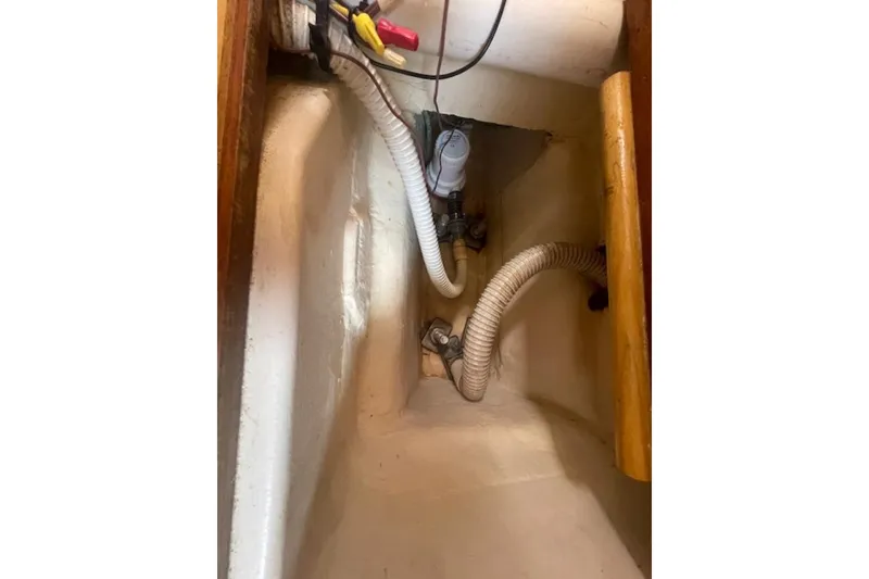 Slide: The Image of Bilge area of a 2001 Hunter 380 sailboat with hoses and wiring. - 20