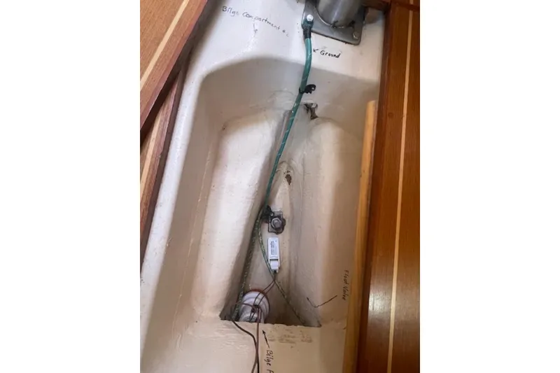Slide: The Image of Bilge compartment of a 2001 Hunter 380 sailboat, showing wiring and labeled components. - 21