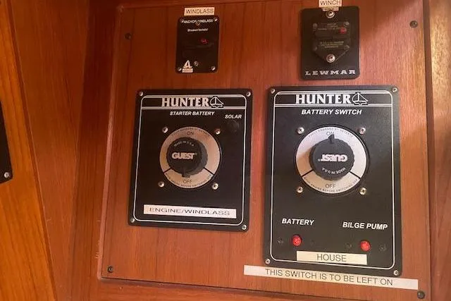 Slide: The Image of Control panel of a 2001 Hunter 380 sailboat with battery switches and windlass controls. - 22