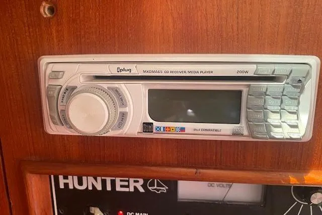 Slide: The Image of CD receiver and media player in a 2001 Hunter 380 boat interior. - 24