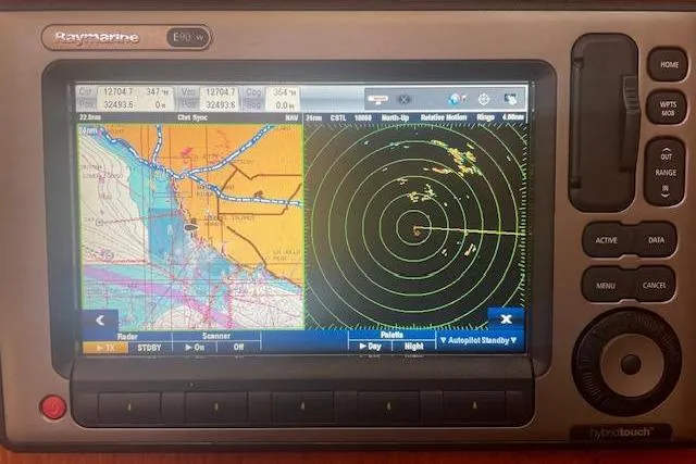 Slide: The Image of Raymarine navigation system displaying nautical chart and radar on a Hunter 380, 2001 model. - 25