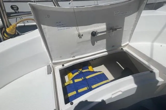 Slide: The Image of Open storage compartment on 2001 Hunter 380 sailboat with life jackets inside. - 27