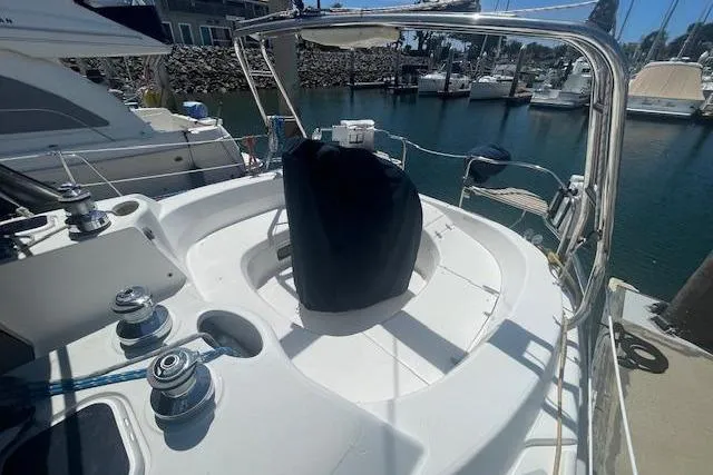 Slide: The Image of Sailboat cockpit of 2001 Hunter 380, docked in a marina with surrounding boats. - 28