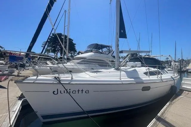 Slide: The Image of 2001 Hunter 380 sailboat named Juliette docked at a marina under clear blue skies. - 3