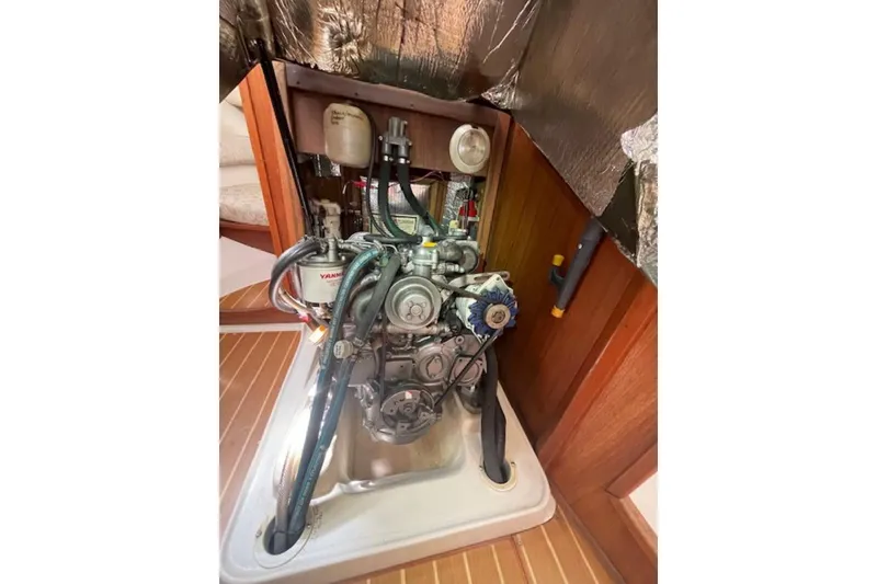 Slide: The Image of Engine compartment of a 2001 Hunter 380 sailboat, featuring a Yanmar engine. - 32