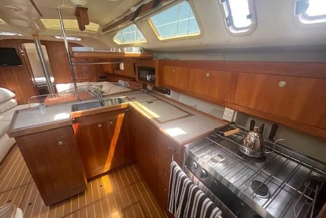 Slide: The Image of Interior of a 2001 Hunter 380 yacht featuring a well-equipped kitchen area. - 5