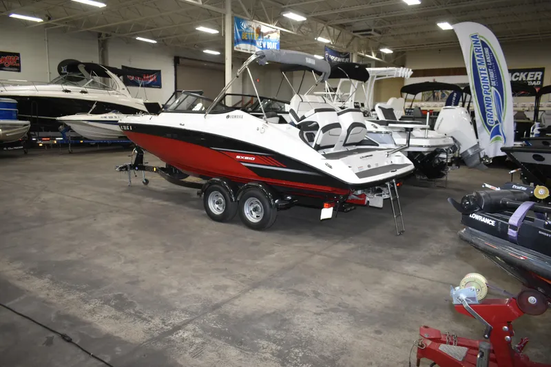 Slide: The Image of 2017 Yamaha SX210 boat displayed in a showroom, featuring sleek design and dual engines. - 2