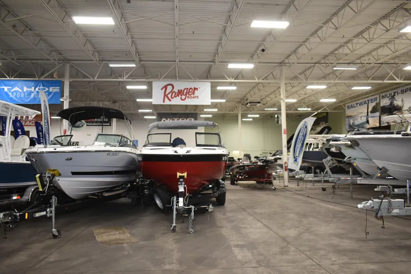Slide: The Image of Indoor boat showroom featuring a 2017 Yamaha SX210 among various models. - 3