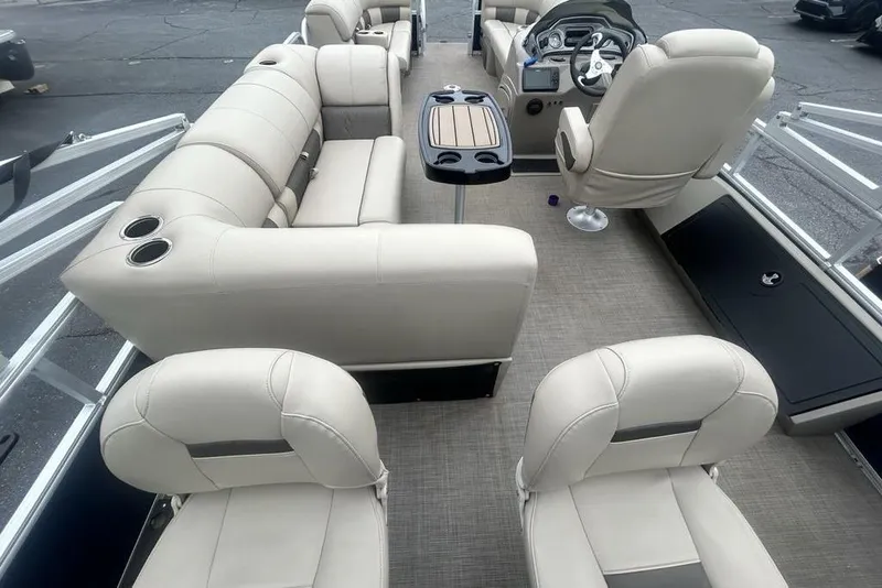 Slide: The Image of 2021 Sun Tracker SportFish 22 DLX pontoon boat interior with beige seating and steering console. - 10