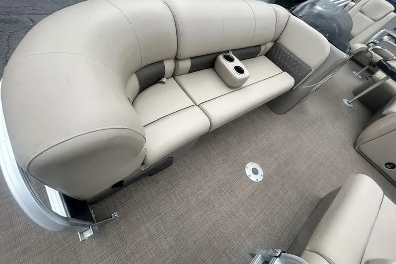 Slide: The Image of 2021 Sun Tracker SportFish 22 DLX pontoon boat interior with beige seating and cup holders. - 12