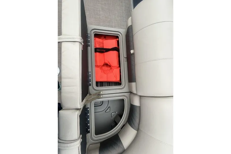 Slide: The Image of Storage compartment with life jackets on a 2021 Sun Tracker SportFish 22 DLX boat. - 14