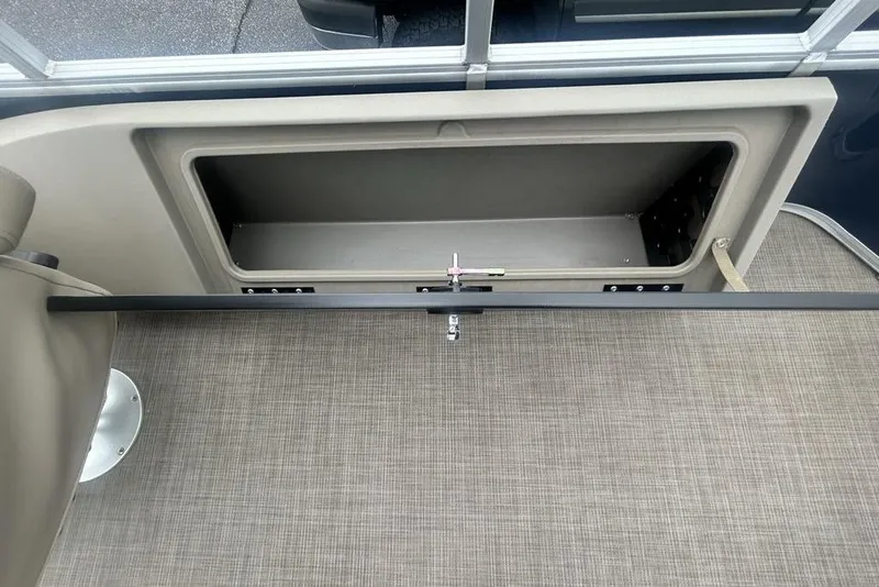 Slide: The Image of Storage compartment on 2021 Sun Tracker SportFish 22 DLX pontoon boat, featuring beige interior. - 15