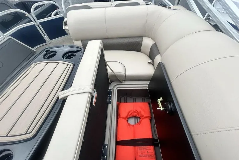 Slide: The Image of 2021 Sun Tracker SportFish 22 DLX boat interior with storage compartment and life jacket. - 21
