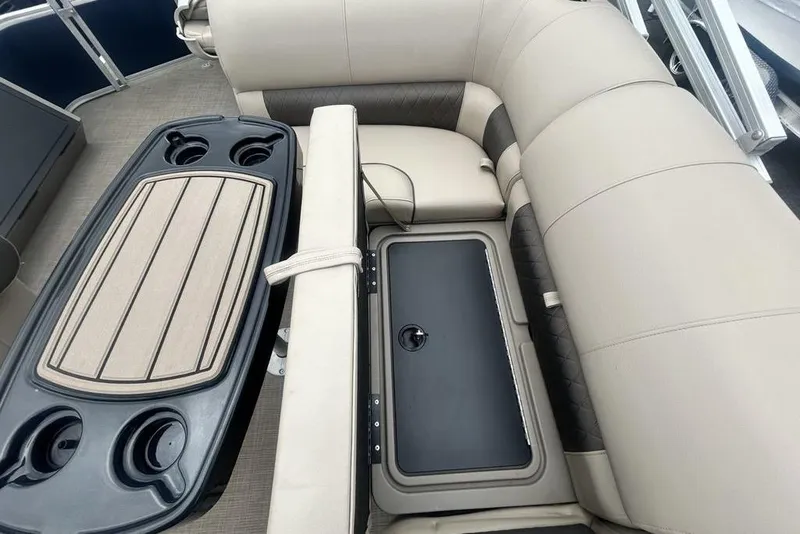 Slide: The Image of 2021 Sun Tracker SportFish 22 DLX interior with beige seating and integrated storage. - 23