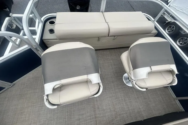 Slide: The Image of 2021 Sun Tracker SportFish 22 DLX boat interior with cushioned seating and cup holders. - 4