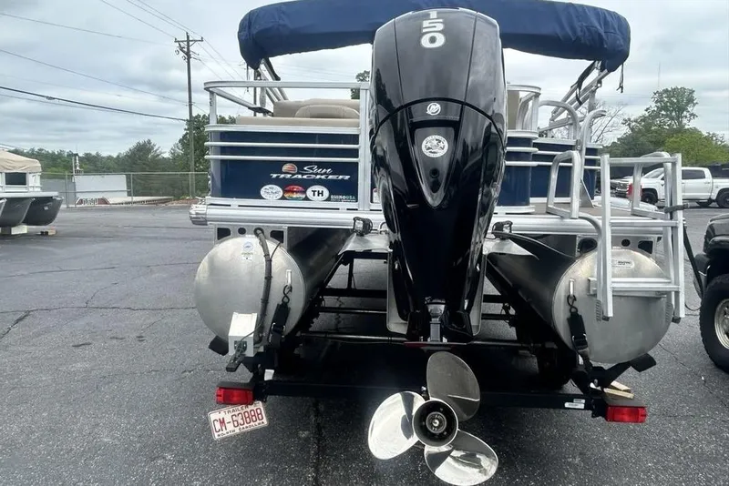 Slide: The Image of 2021 Sun Tracker SportFish 22 DLX pontoon boat with powerful outboard motor, parked on trailer. - 5