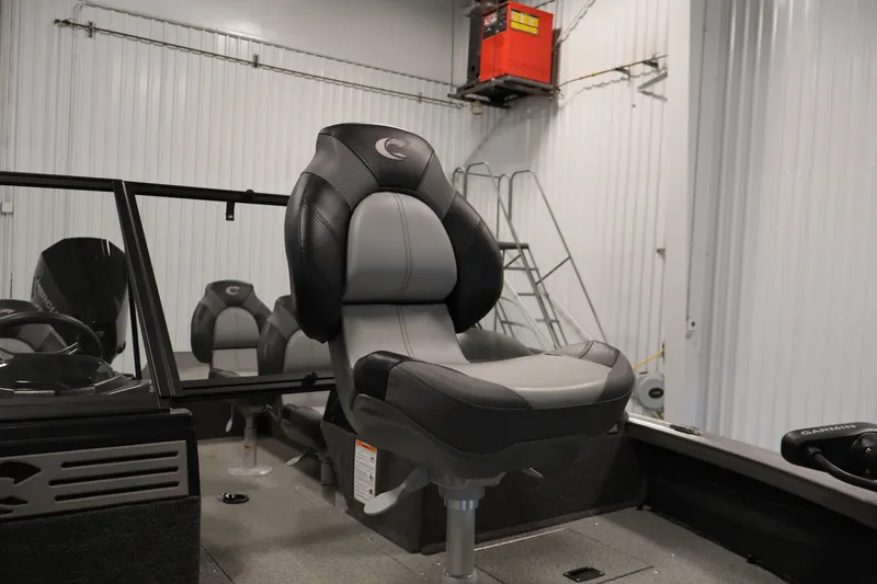 Slide: The Image of 2025 Crestliner 1950 Fish Hawk WT boat interior with comfortable seating in a showroom. - 15