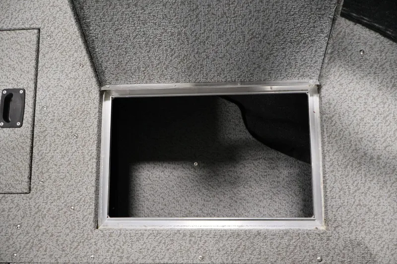 Slide: The Image of Storage compartment in 2025 Crestliner 1950 Fish Hawk WT boat, featuring textured interior. - 16