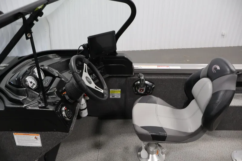 Slide: The Image of 2025 Crestliner 1950 Fish Hawk WT boat interior with steering wheel and captain's chair. - 21