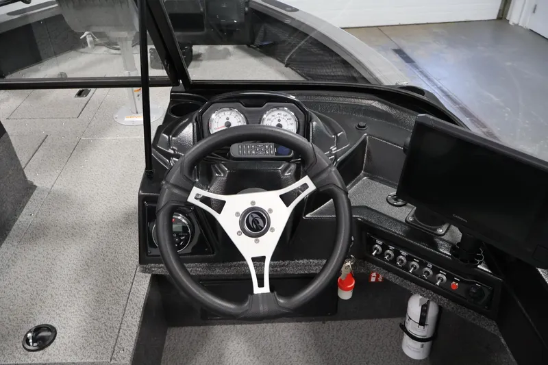 Slide: The Image of 2025 Crestliner 1950 Fish Hawk WT dashboard with steering wheel and control panel. - 22