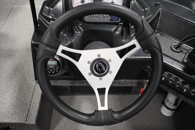 Slide: The Image of Steering wheel of 2025 Crestliner 1950 Fish Hawk WT boat, featuring modern dashboard controls. - 23