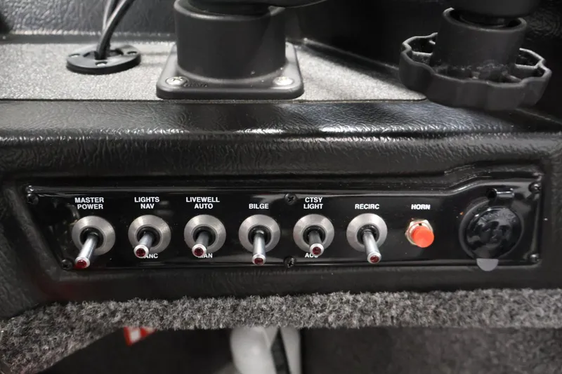 Slide: The Image of Control panel of 2025 Crestliner 1950 Fish Hawk WT boat with various switches and controls. - 27