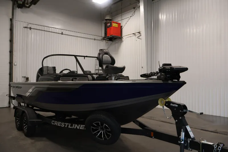 Slide: The Image of 2025 Crestliner 1950 Fish Hawk WT boat in indoor showroom on trailer. - 3