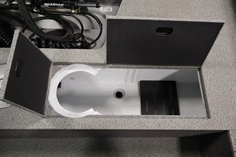 Slide: The Image of 2025 Crestliner 1950 Fish Hawk WT boat storage compartment with open hatch and visible wiring. - 36