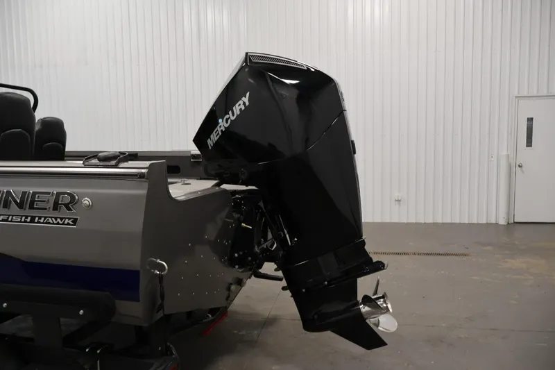 Slide: The Image of 2025 Crestliner 1950 Fish Hawk WT with Mercury outboard motor in a showroom. - 38