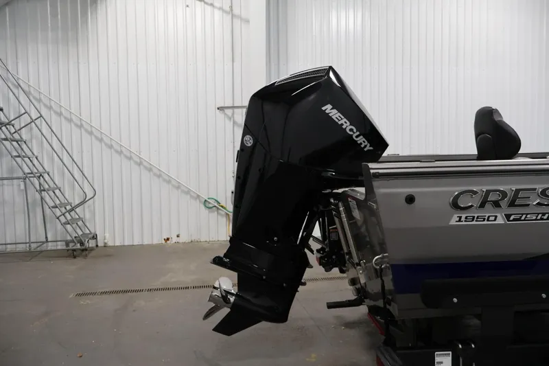 Slide: The Image of 2025 Crestliner 1950 Fish Hawk WT boat with Mercury outboard motor in a garage. - 39