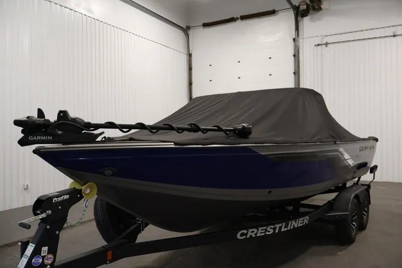 Slide: The Image of 2025 Crestliner 1950 Fish Hawk WT boat with cover in a garage setting. - 46