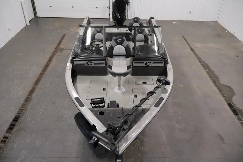 Slide: The Image of 2025 Crestliner 1950 Fish Hawk WT boat in a showroom, featuring sleek design and modern seating. - 9