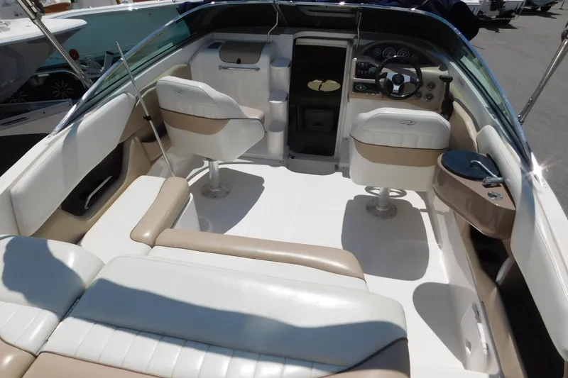 Slide: The Image of Interior of a 2004 Regal 2250 LSC boat with beige and white seating. - 10
