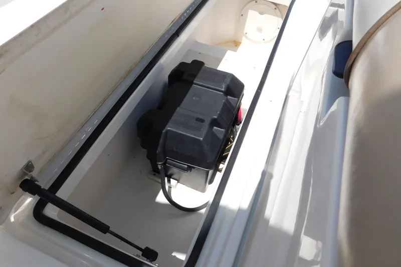 Slide: The Image of Battery compartment of a 2004 Regal 2250 LSC boat, featuring a secured battery. - 11