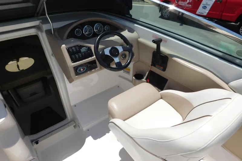 Slide: The Image of Interior of a 2004 Regal 2250 LSC boat showing steering wheel and controls. - 12